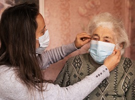 old woman in PPE mask
